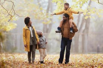 Decorative image of a family walking in the fall