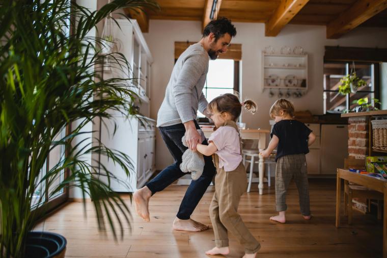 family dancing in kitchen