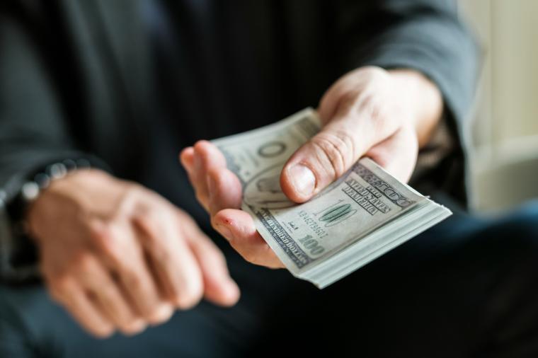 man holding US currency