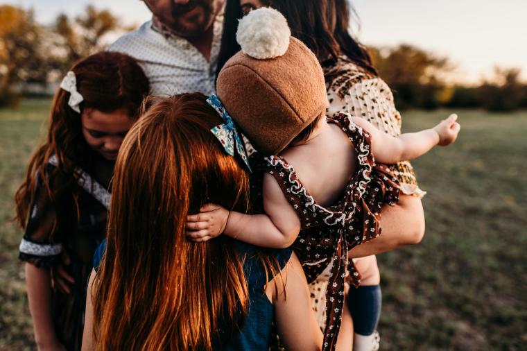 family hugging outside