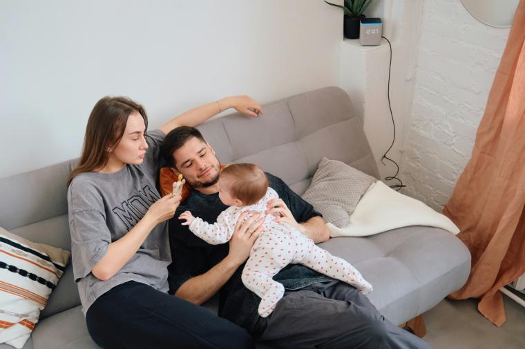 parents on couch with infant