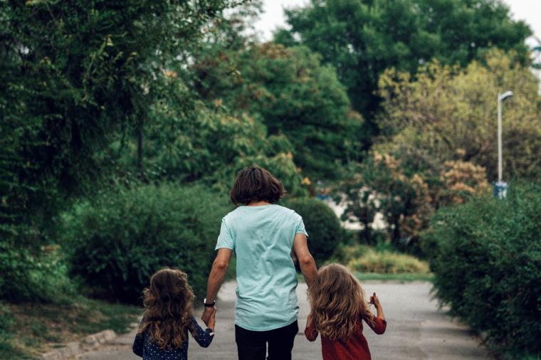 family walking on sidewalk