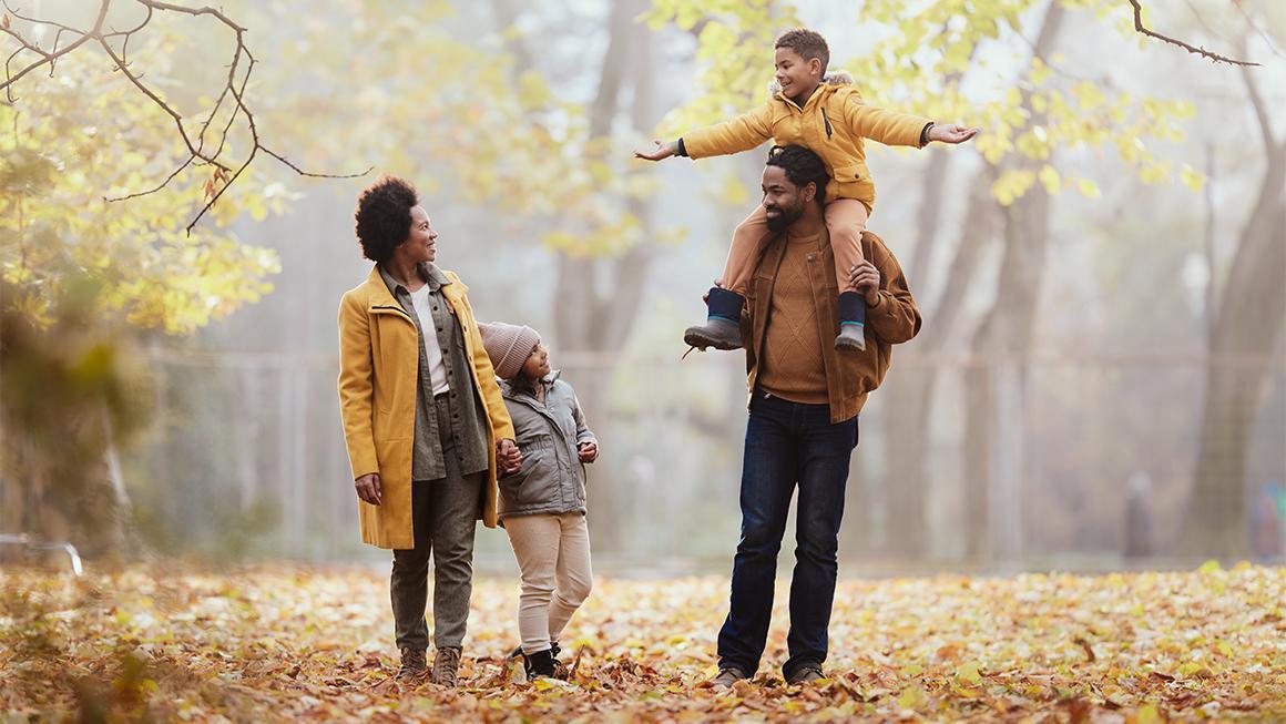 Decorative image of a family walking in the fall