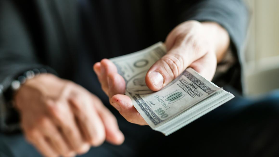 man holding US currency